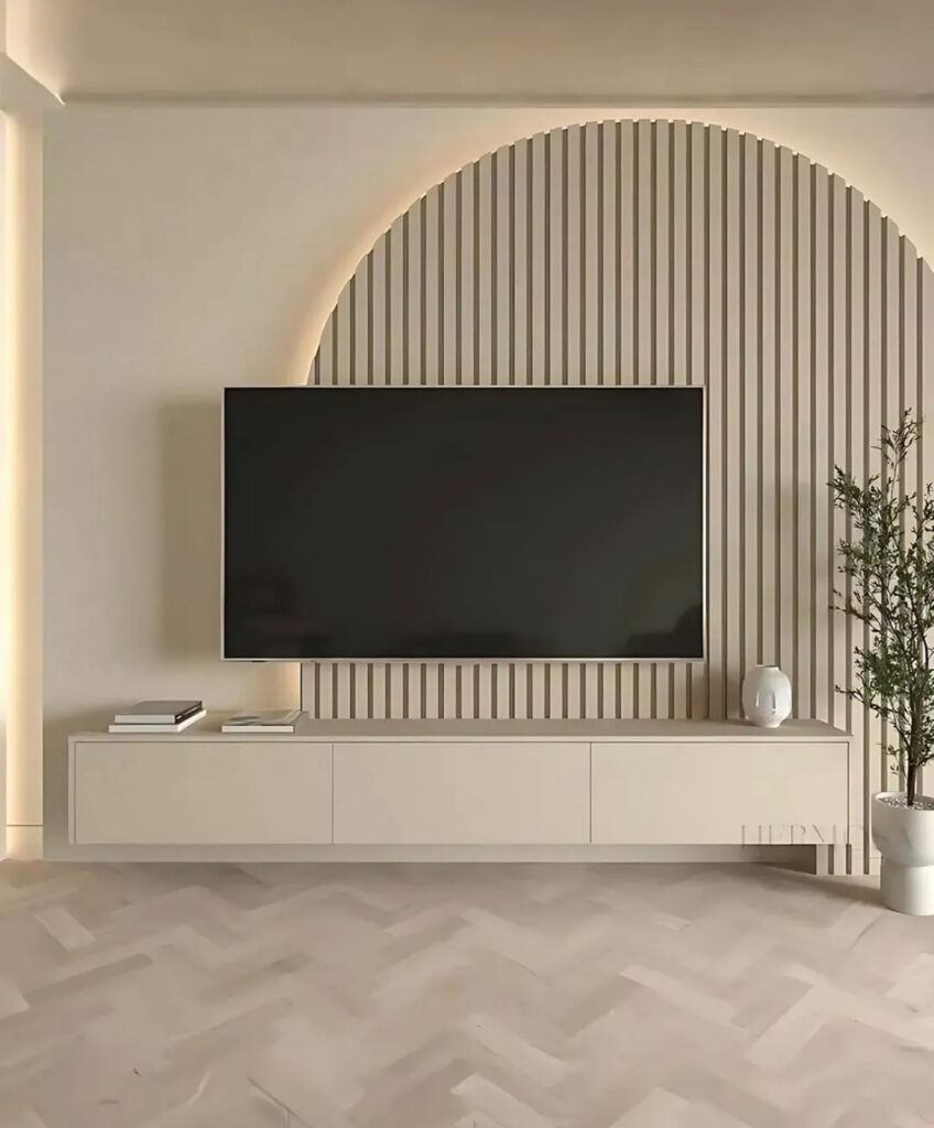 Curved slatted feature panel, floating cabinet, and simple ceramics as warm living room accent wall ideas with tv for soft contemporary homes.