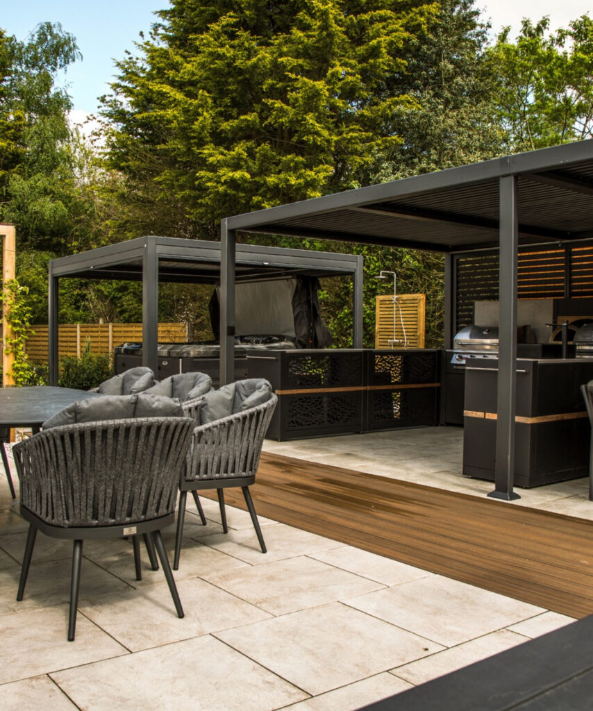 Two metal pergolas shading dining and grill areas that showcase flexible backyard outdoor kitchen ideas