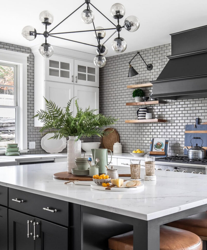high contrast black island white cabinets gray subway tile dramatic classic lake house kitchen