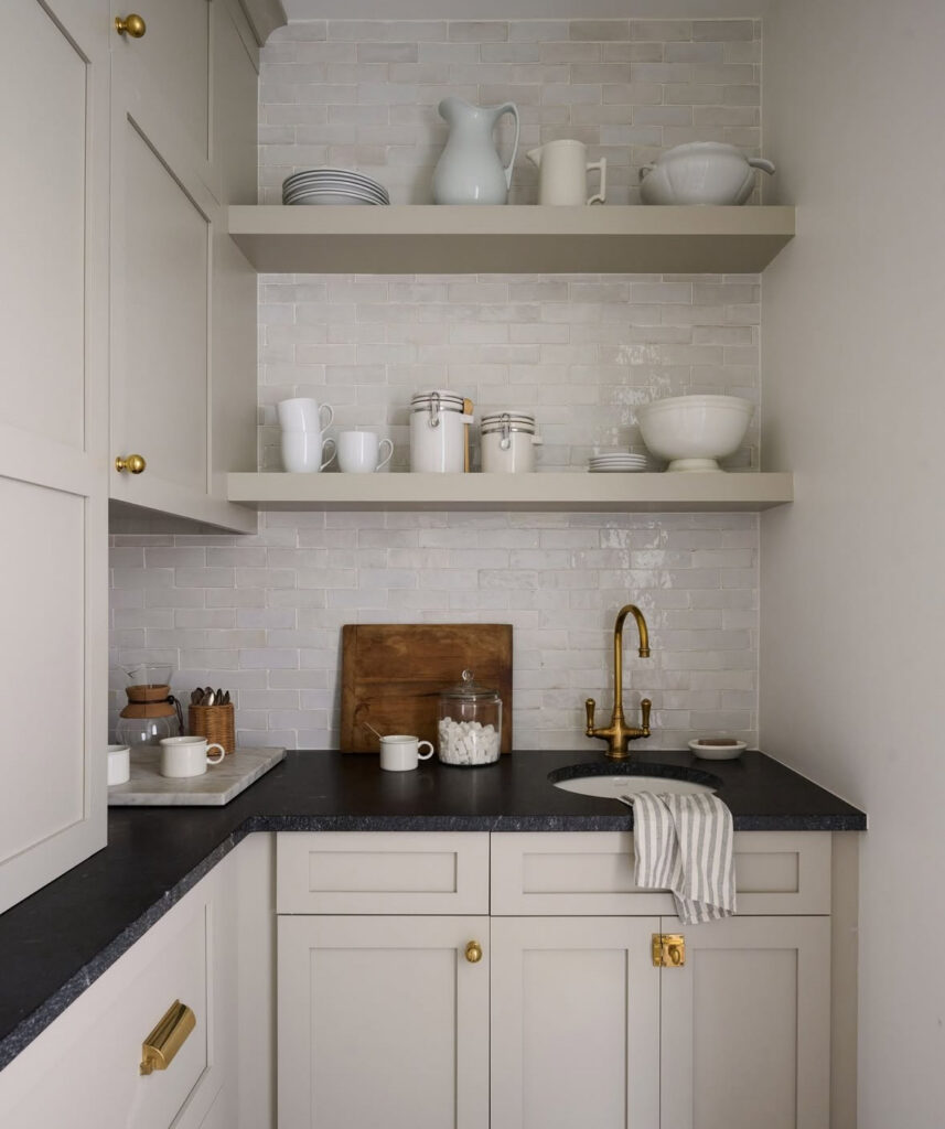 soft taupe cabinetry brass faucet and open shelves show classic butlers pantry walk in pantry ideas in a compact prep zone