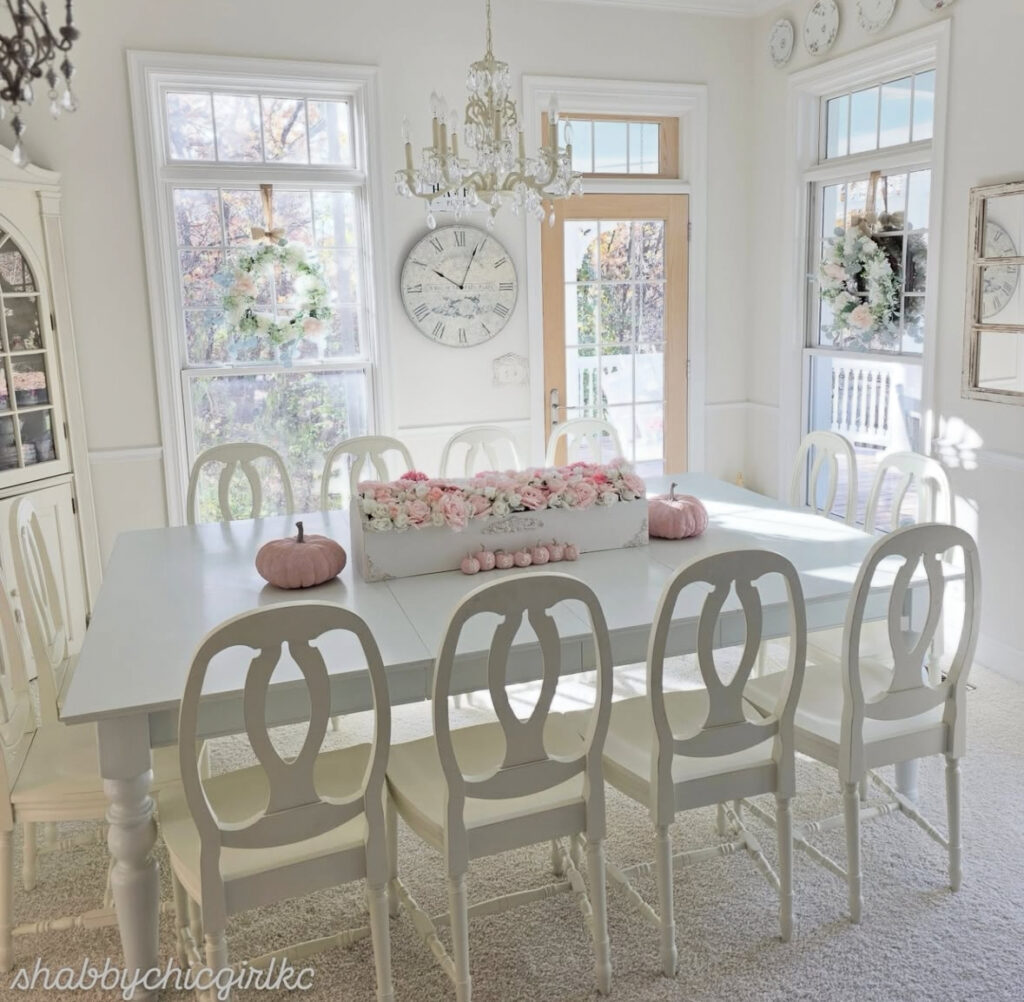Bright white dining room with long table and chandeliers for shabby chic home decor ideas.