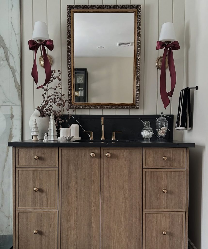 Bathroom decorated with burgundy bows and festive holiday touches
