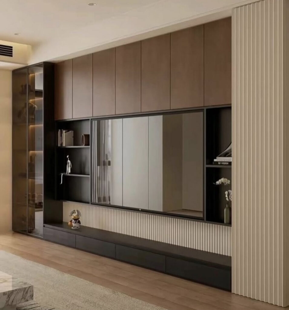 Tall storage cabinets, open shelves, and a centered television showcasing sleek tv wall decoration ideas for living room layouts that need extra storage.