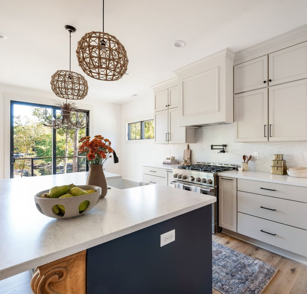 light cabinets navy island glass door to balcony indoor outdoor flow open concept lake house kitchen