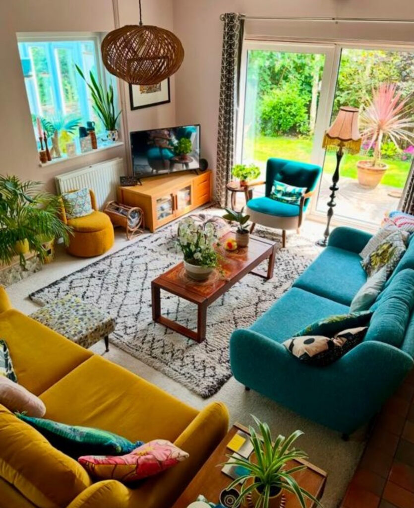 Colorful living space filled with plants, mustard and teal sofas, and mid-century touches, inspiring fresh eclectic home decor ideas.