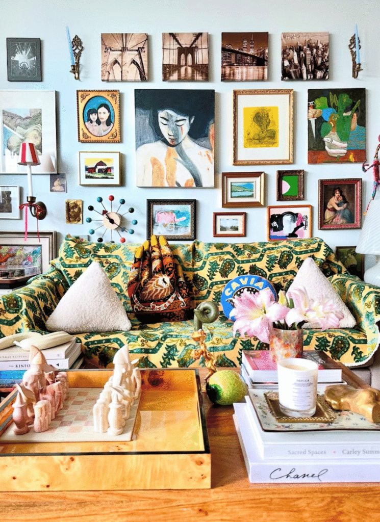 Living room with patterned sofa, layered artwork, and styled coffee table — the perfect expression of artistic eclectic home decor style.
