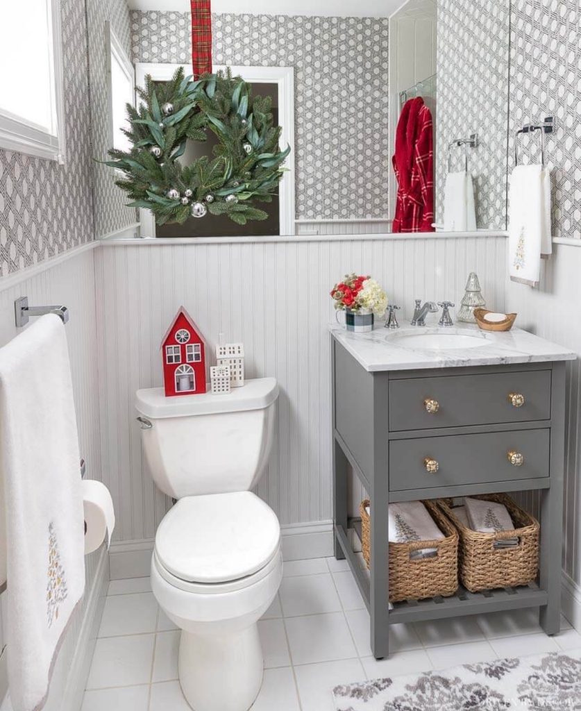 Small bathroom with a gray vanity and Christmas wreath
