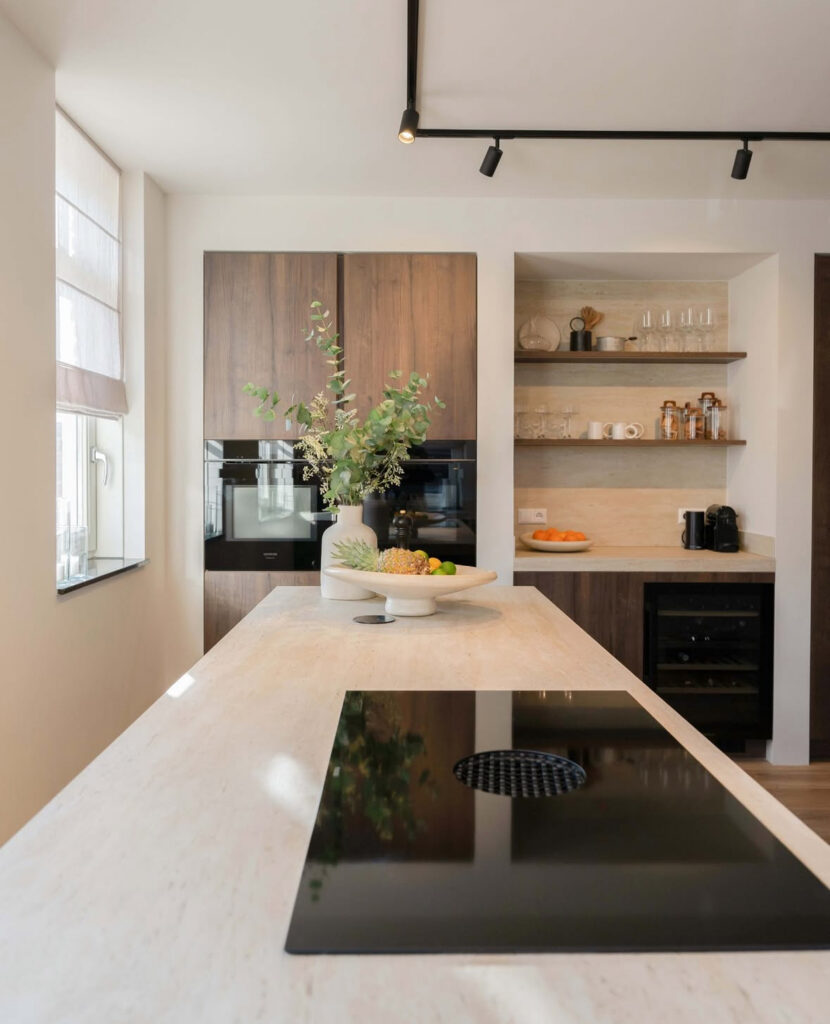 Japandi kitchen with stone backsplash and matching floating shelf.