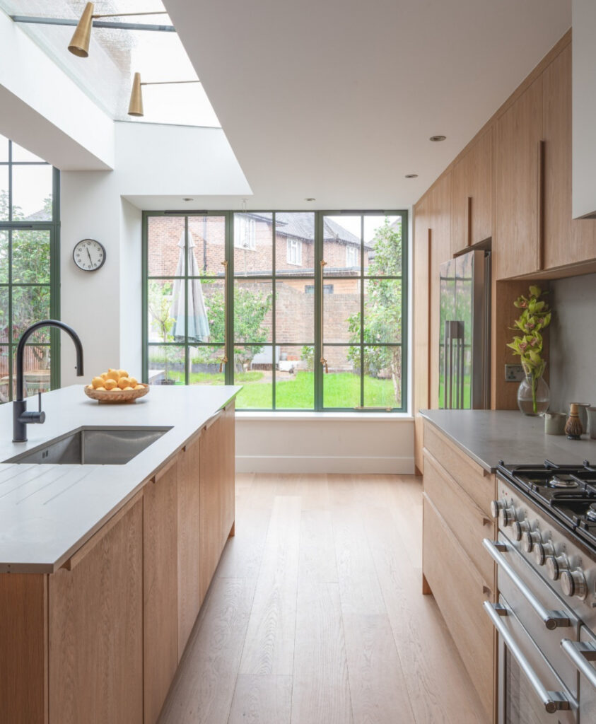 Japandi kitchen with skylight and a serene view of the garden.