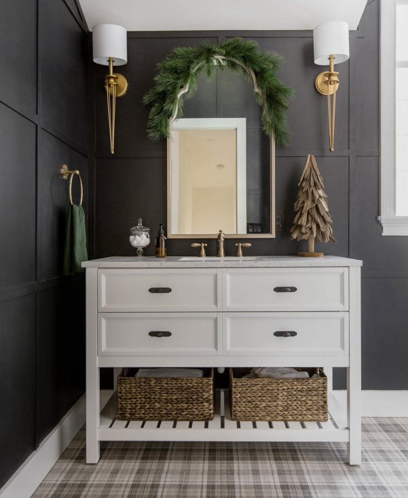 Black and brass bathroom with moody Christmas decor