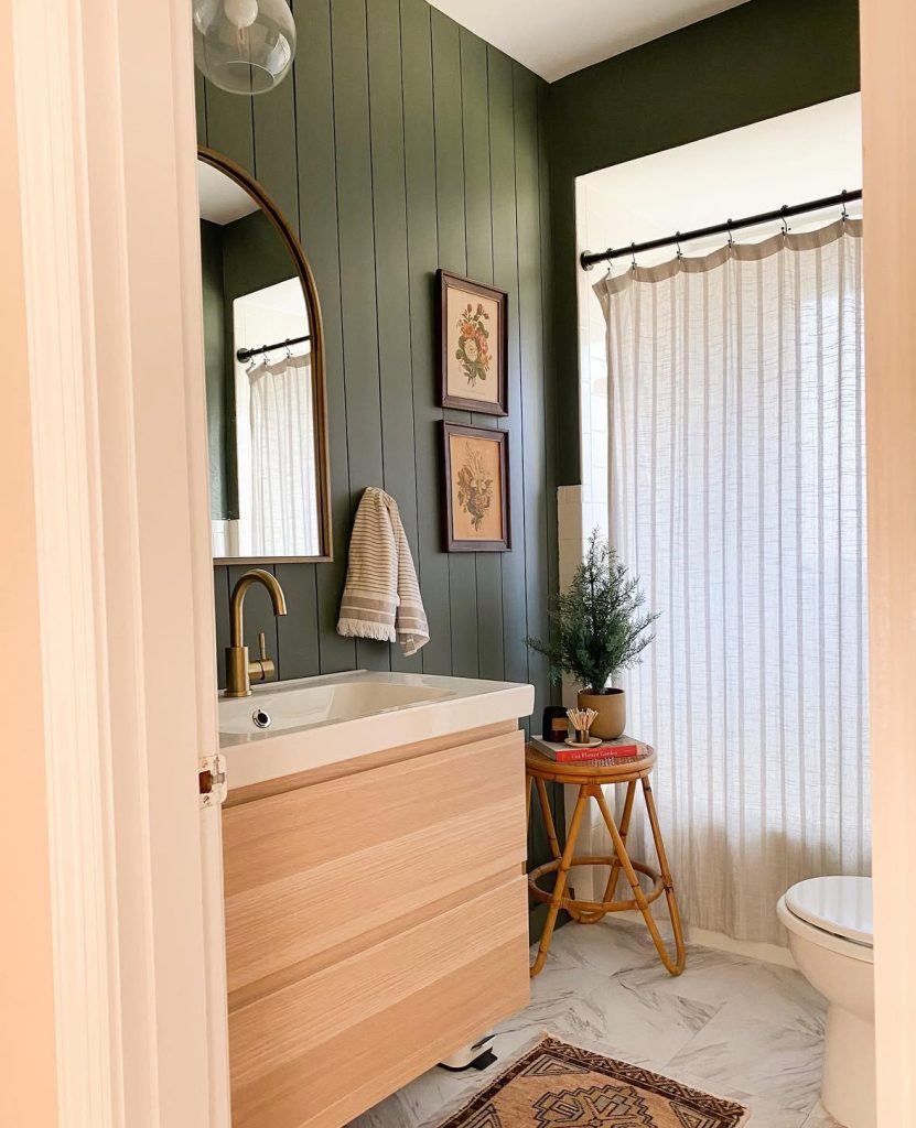 Small bathroom with olive paneling and holiday decor