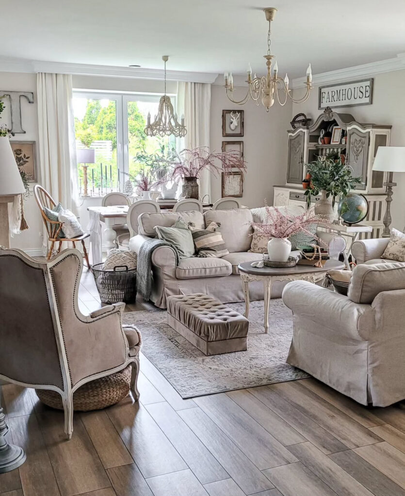 Open farmhouse living and dining area in soft neutrals offering layered shabby chic decor ideas.