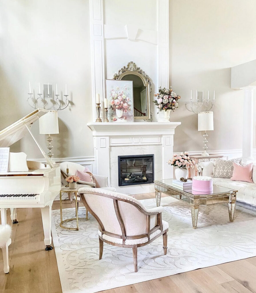 White grand piano, blush pillows, and a tall fireplace surround offer romantic french country living room ideas for a music room.