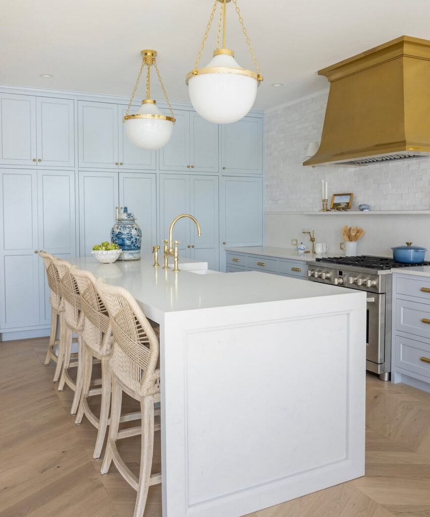 powder blue cabinetry brass hood globe pendants elegant lake house kitchen ideas with long island