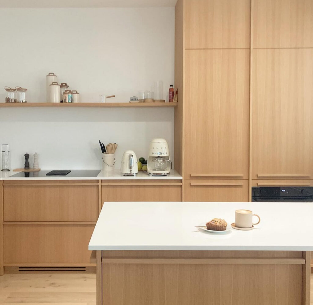 Compact Scandinavian–Japandi kitchen with light wood cabinetry.