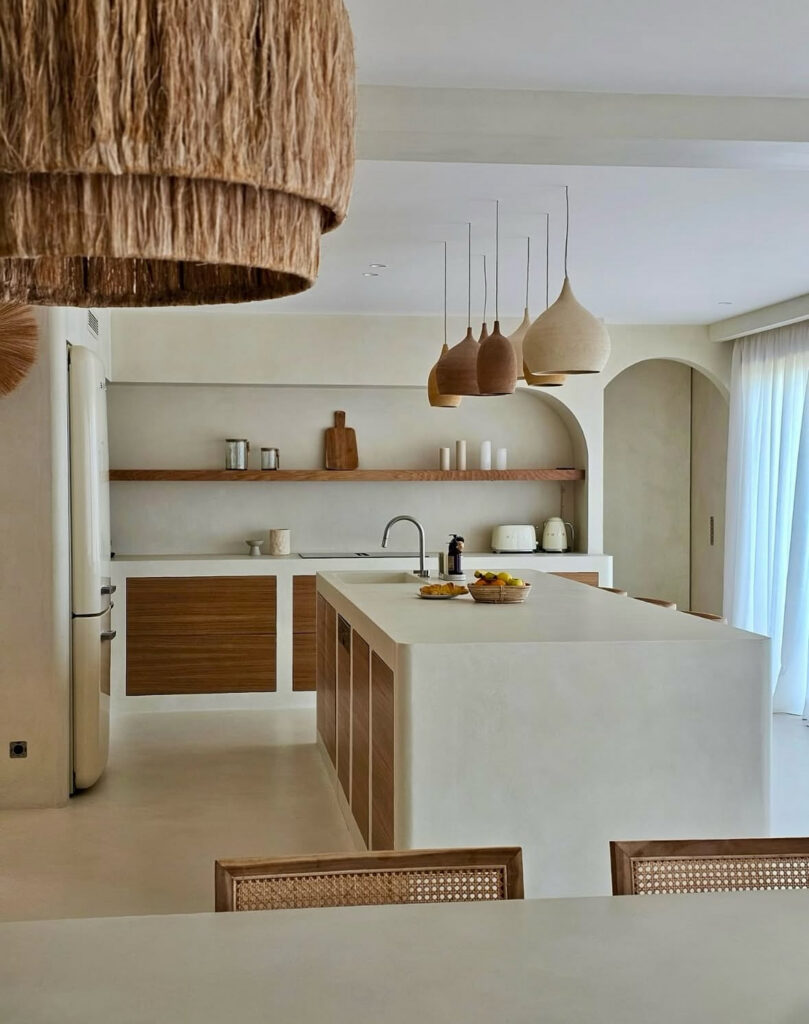 Scandinavian–Japandi kitchen featuring white cabinetry and warm wood tones.