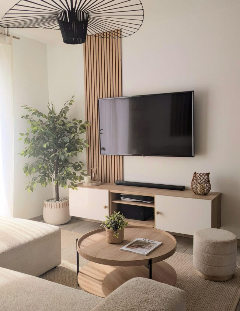 Slim vertical slatted panel behind the television and simple console styling that can inspire corner wall mount tv ideas for living room layouts and small apartments.