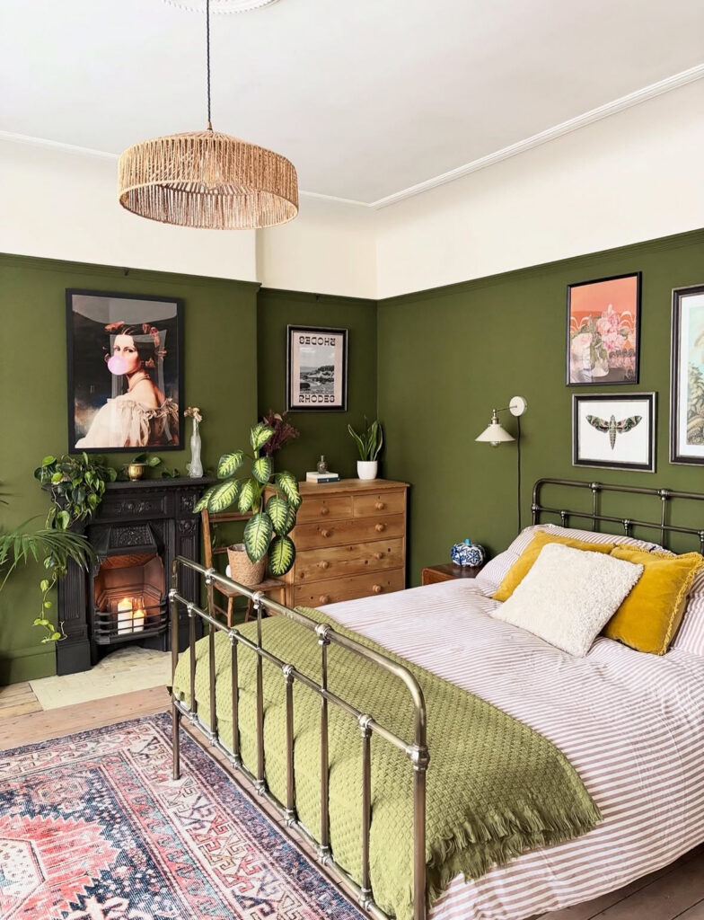 Olive green bedroom with iron bed and vintage dresser, blending cozy charm and timeless vintage eclectic home decor.