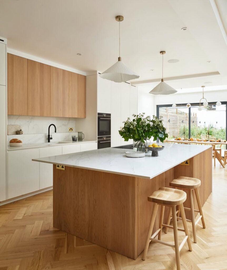 Wabi-sabi inspired Japandi kitchen with a fluted wood island.