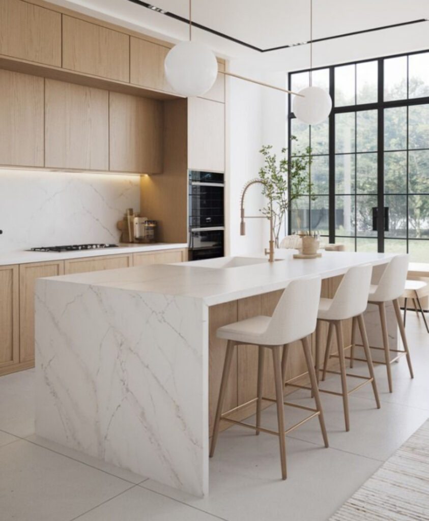 Wabi-sabi Japandi kitchen with a golden water faucet nda stone waterfall island.