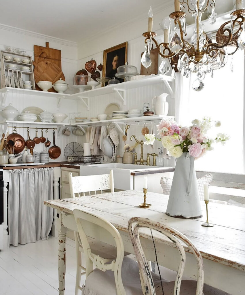 White farmhouse kitchen with open shelves and copper accents showing shabby chic decor ideas.