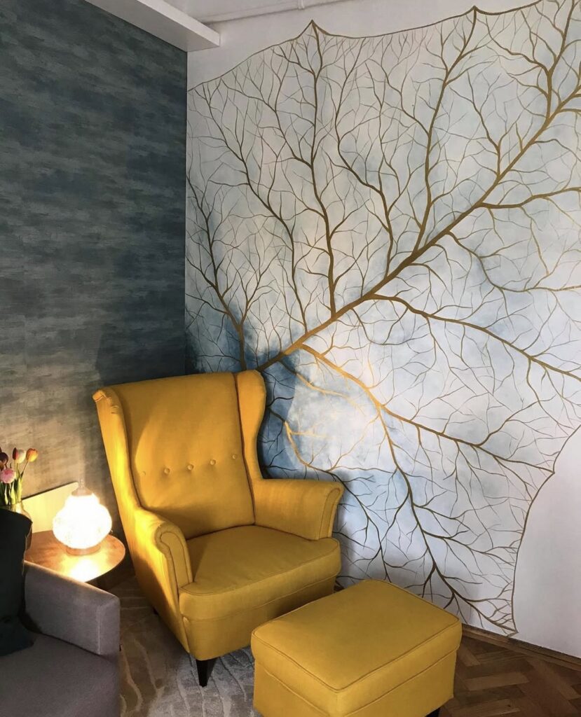 hand-painted mural and small side table showing unique inexpensive home decor