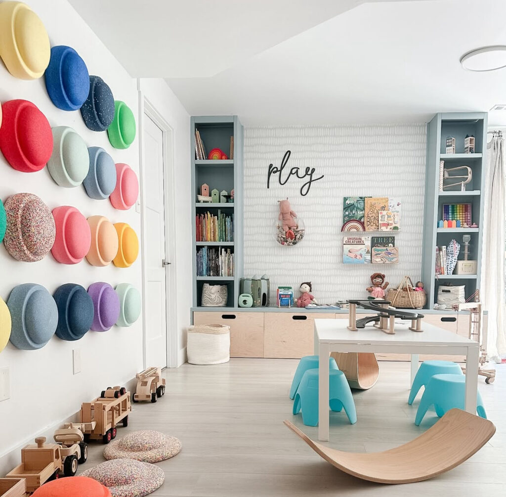 Airy modern playroom with wall-mounted hats, built-ins, and open floor space for play.