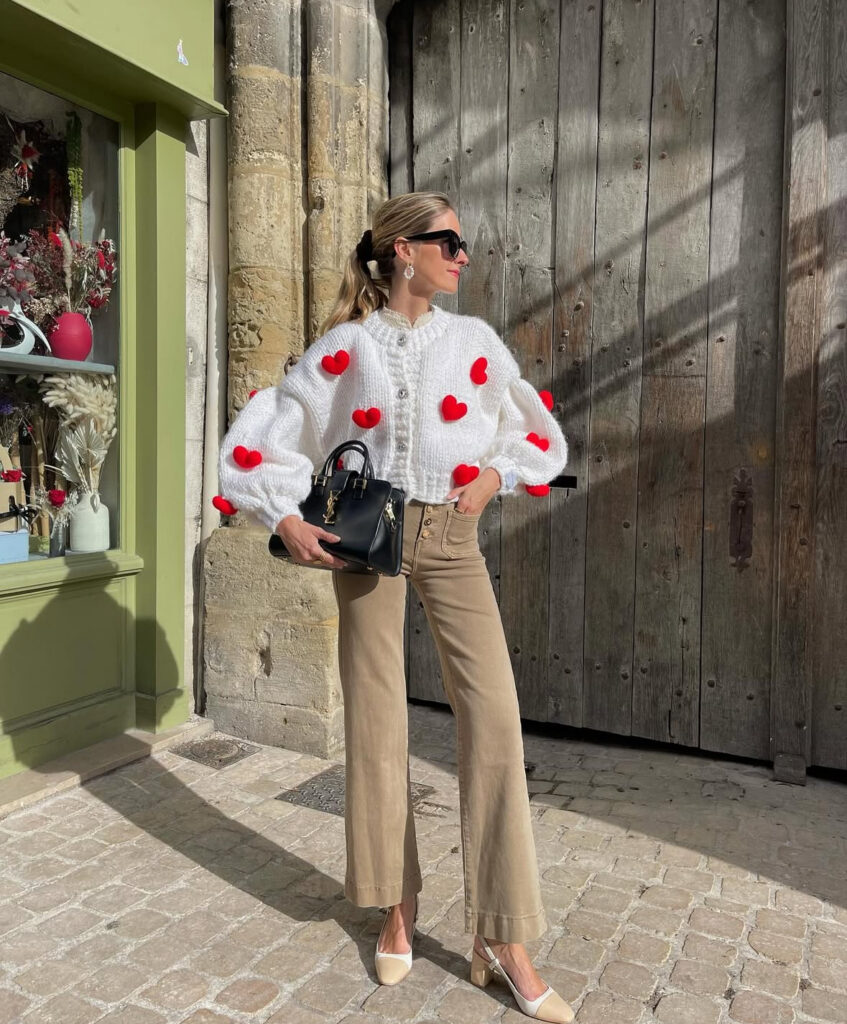 Casual Valentines Day outfit: heart sweater with neutral trousers—cute, comfy, and still on-theme.