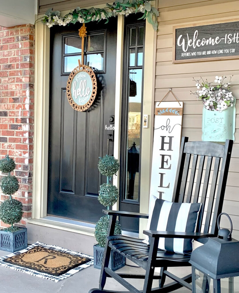 classy st patricks day front porch with a black door, topiaries, neutral styling, and a simple green nod.