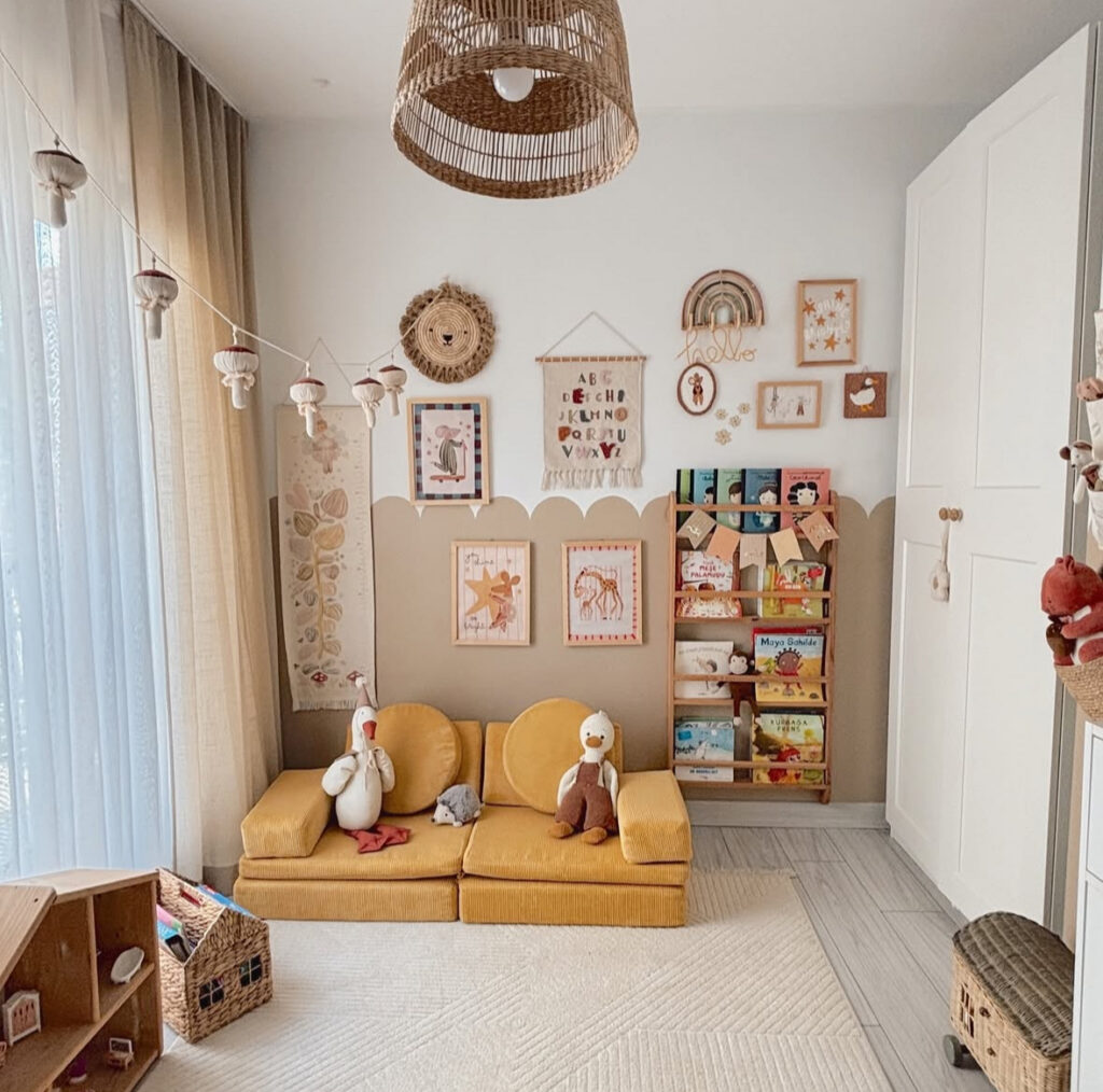 Cozy playroom reading nook with a forward-facing bookshelf, soft seating, and warm styling.