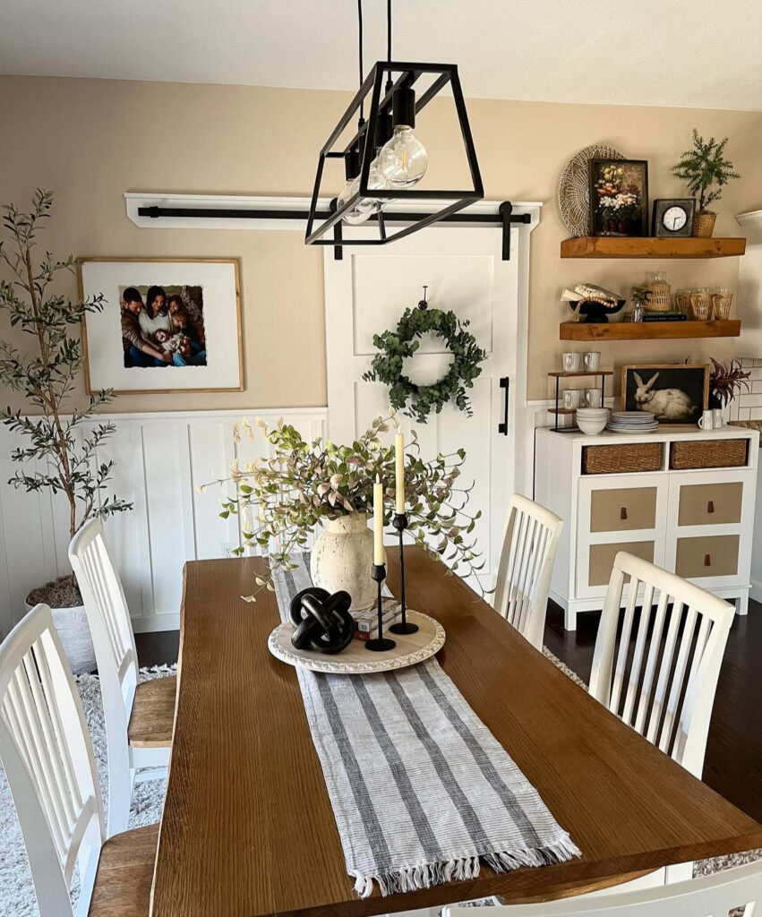 st patricks day color scheme in a neutral dining room with a green wreath, soft greenery, and warm wood tones.