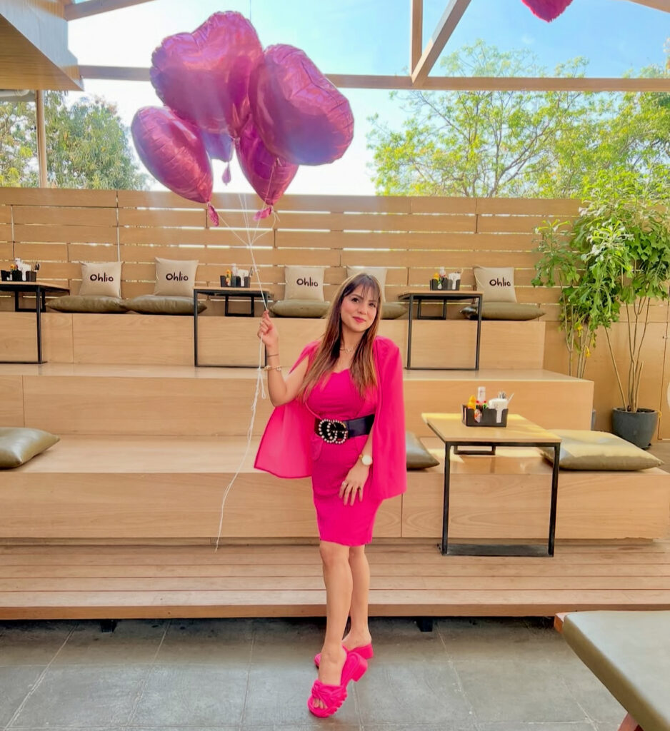 Woman wearing a bright pink mini dress styled as a cute Galentine’s Day outfit outdoors