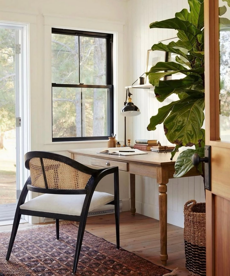 Inspirational office wall art in neutral tones decor: three botanical prints above a white desk with lamp and simple zen-inspired styling