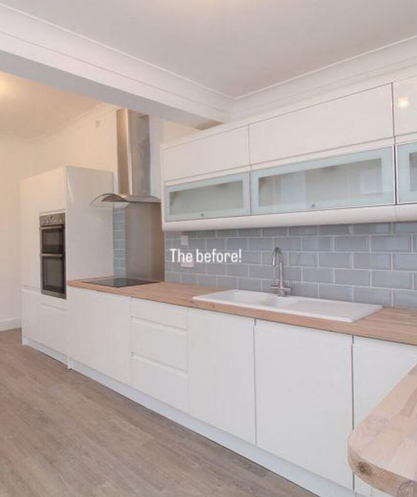 Plain white kitchen with flat-front cabinets and a neutral floor before the bold green kitchen remodel ideas from @abbysathome.