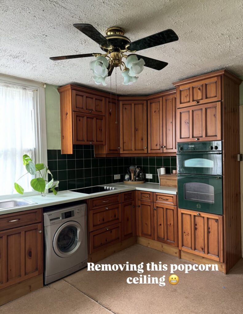 Period kitchen with knotty pine cabinets, green tile and carpeted floor before the bold makeover by @thistimeincolour.