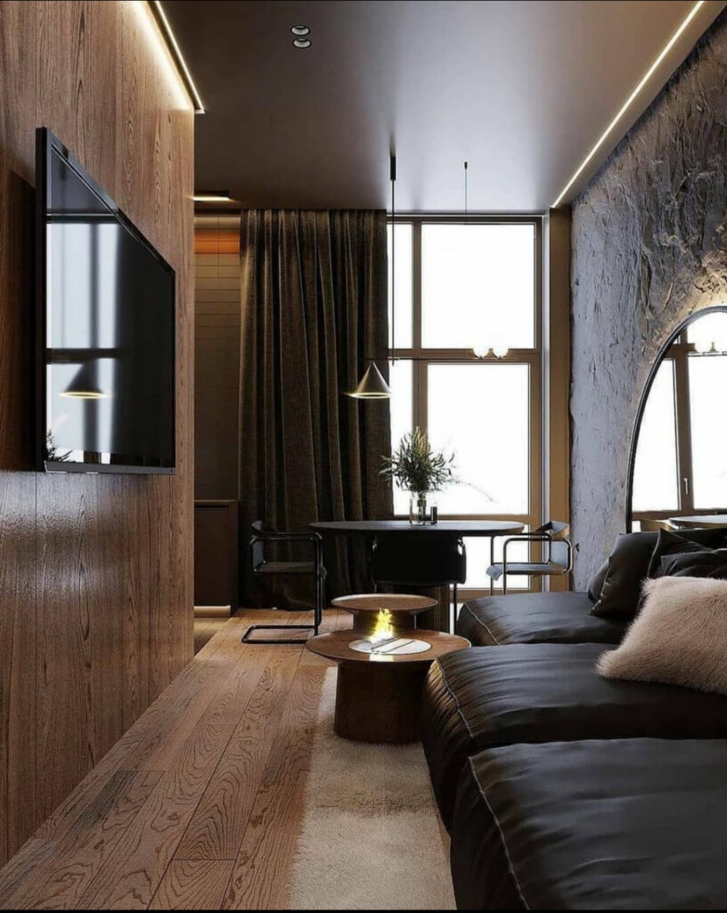 Minimalist living space highlighted by sculptural lighting fixtures and soft, indirect light.