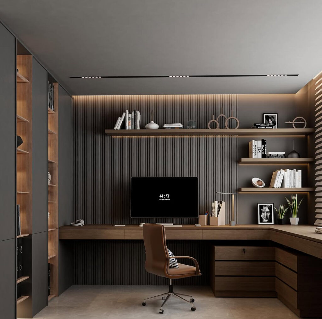 Sleek masculine office with dark vertical slatted wall, warm wood L-shaped desk, built-in shelving, integrated LED lighting and a tan modern office chair