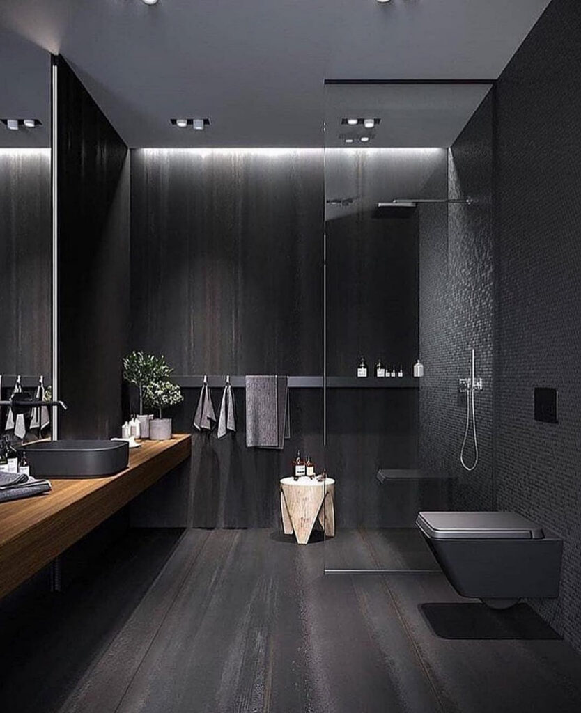 Floating vanity and dark walls highlighting a serene minimalist black bathroom.