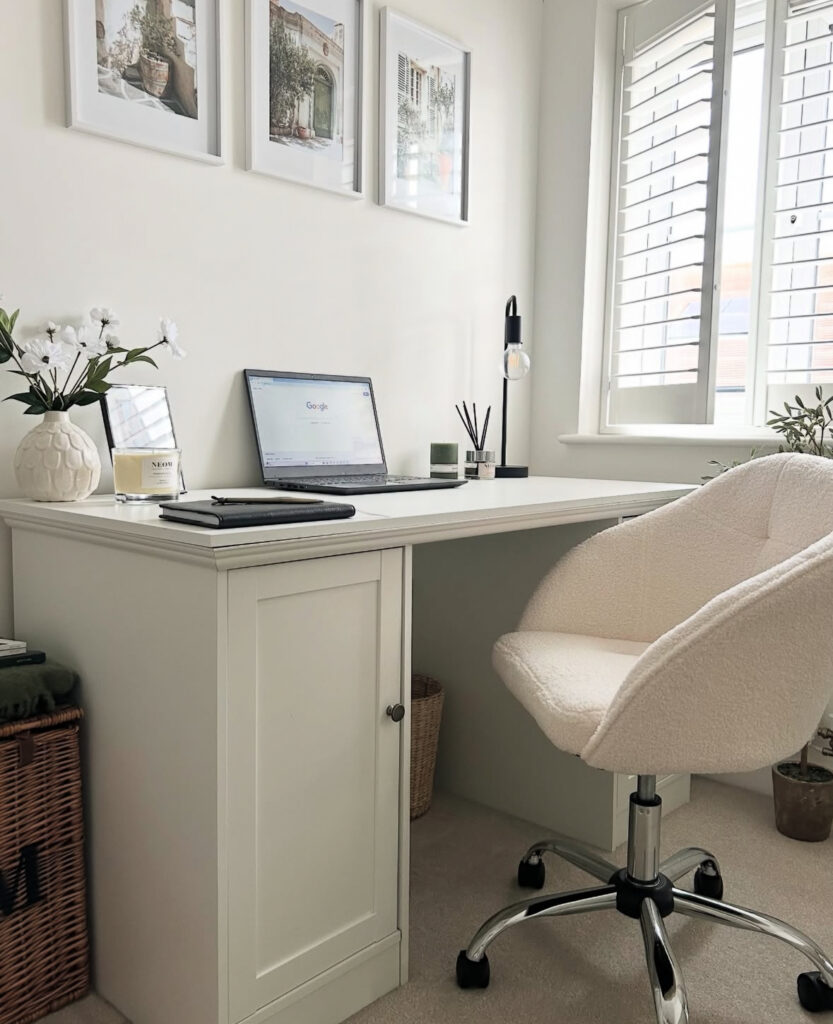 Minimal white desk setup with boucle chair, simple styling, and clean surfaces, minimalist workspace that still feels cozy.