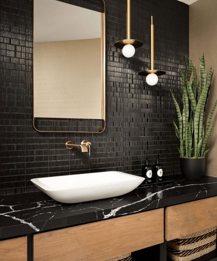 Rectangular tile vanity with brass mirror and clean lines, representing modern black bathrooms.