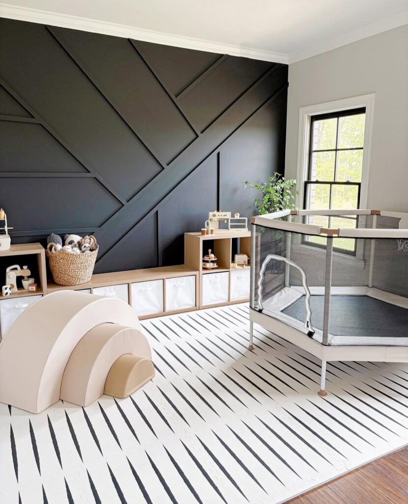 Modern playroom with a black accent wall and a bold black-and-white floor mat for play zoning.