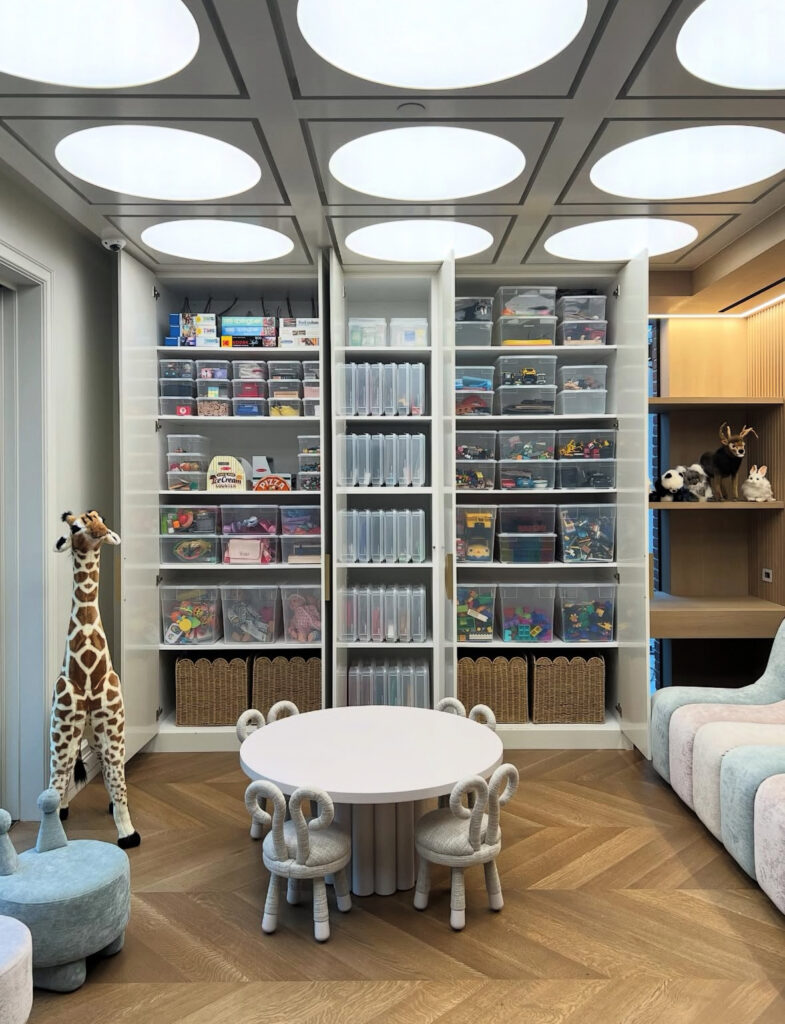 Playroom activity corner with storage and open floor space for building and creative play.