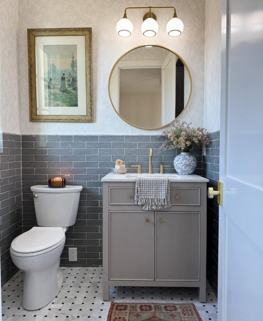 Compact gray and white powder room offering small vintage bathroom ideas with brick tile and round mirror.