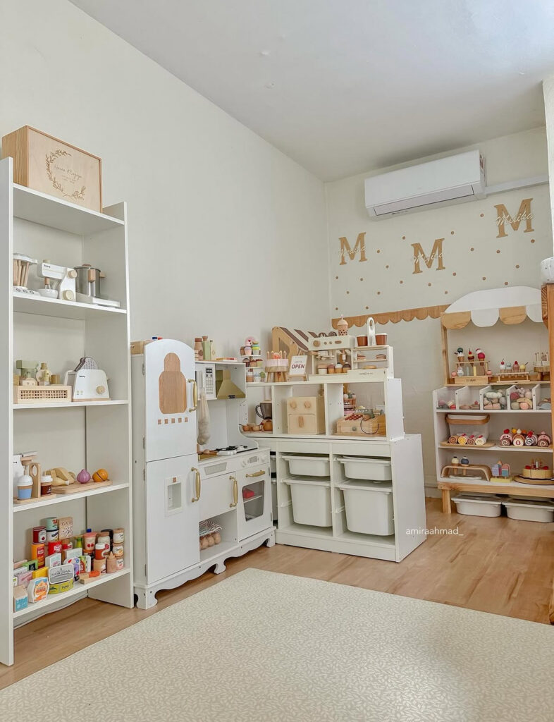 Pretend play café and kitchen area with shelves and bins for organized role-play storage.