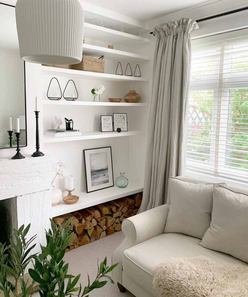 Katie’s calm Scandi-inspired lounge with built-in shelves, candles, baskets and simple decorative pieces creating layered living room decor on a budget.