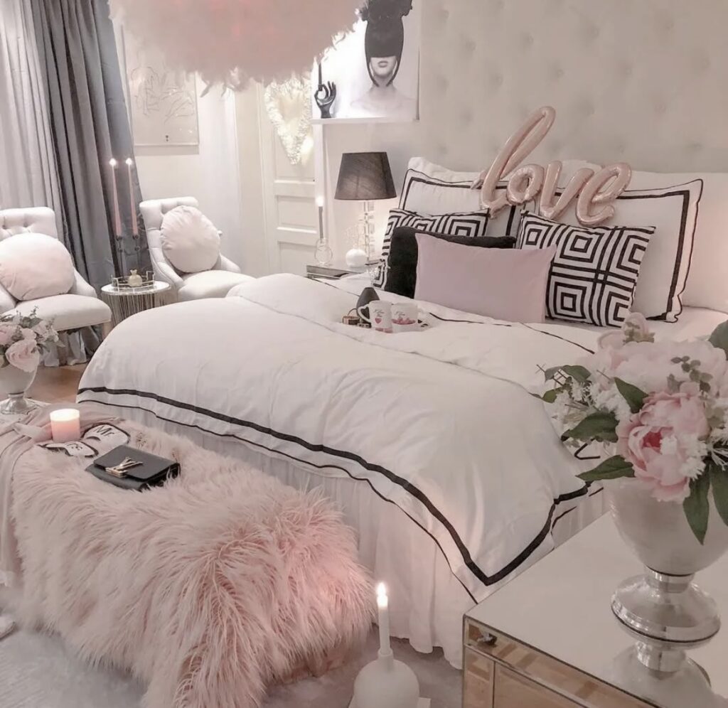 Elegant pink and white bedroom with fur bench, candles, and a “love” pillow—romantic valentines day bedroom decor style.