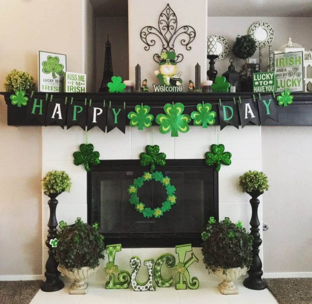st patricks day decorations on a fireplace mantel with shamrock garland, bold green accents, and “LUCK” decor.