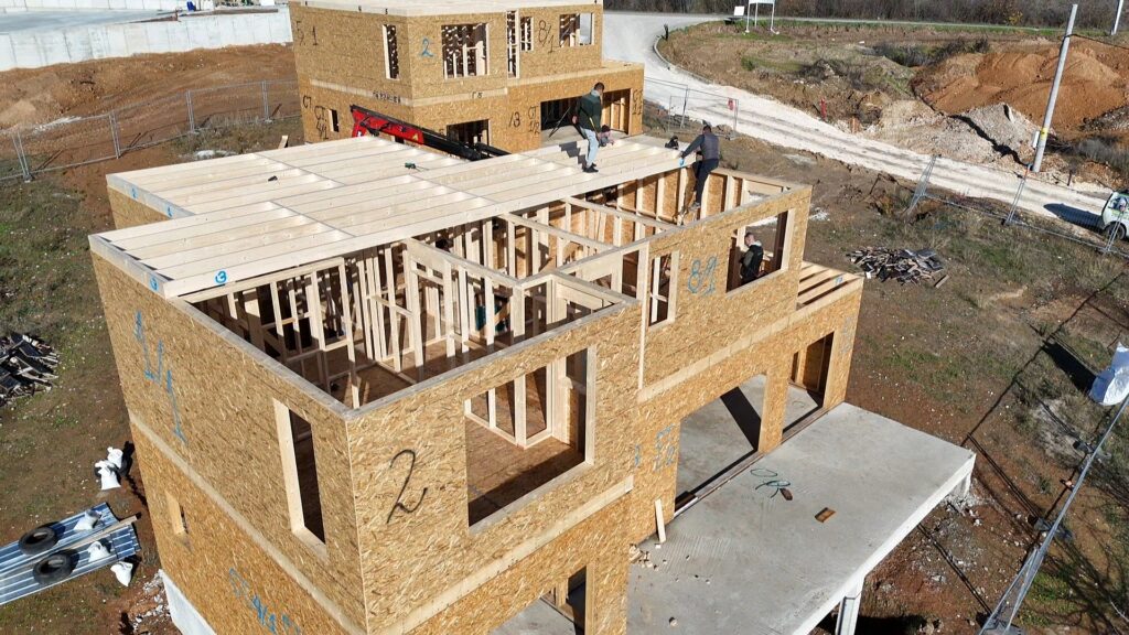 Timber frame roof framing on the lower roof area with joists being aligned and fixed in place