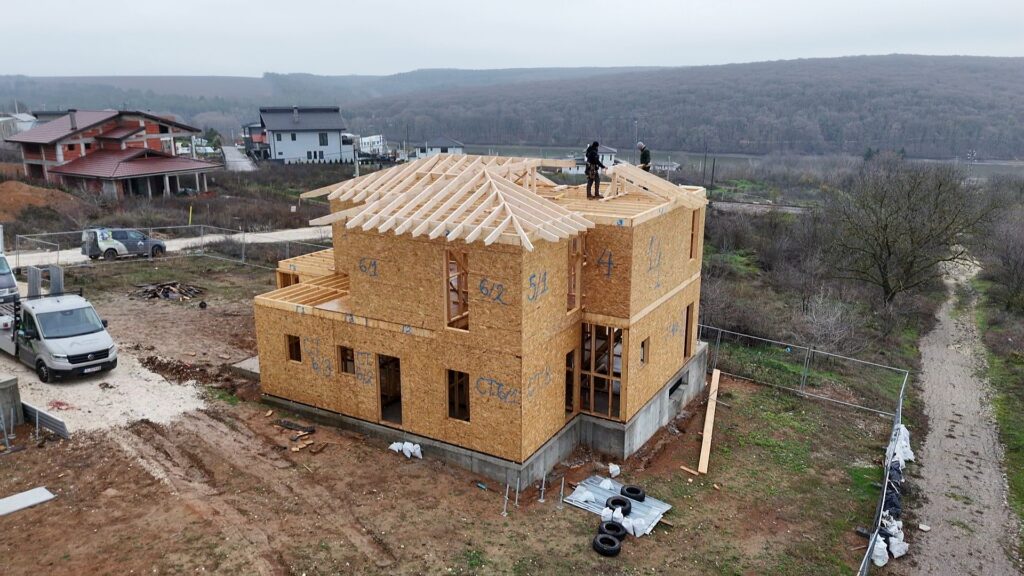 Wide view of roof skeleton with hip rafters installed and geometry taking shape
