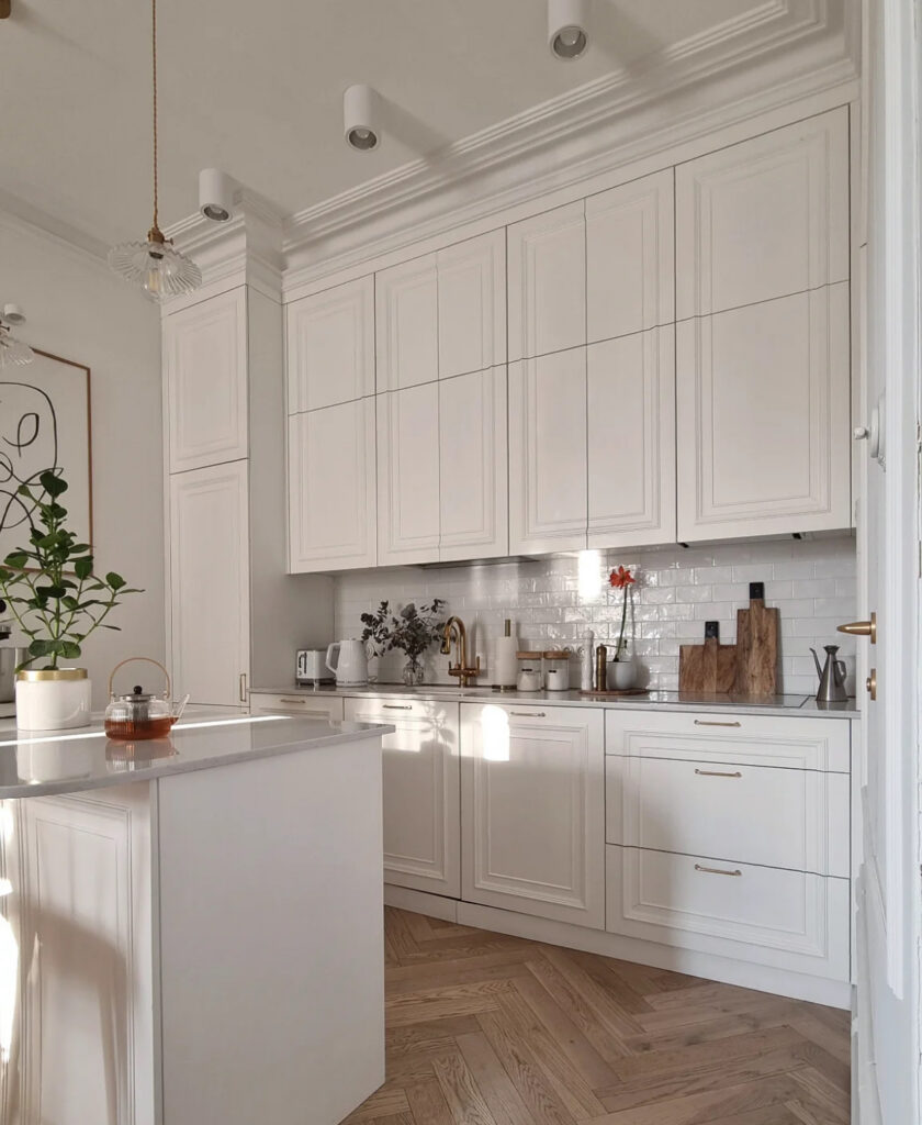 Greige shaker cabinets, white subway tile, and herringbone floors styled by @interiorbysarahstrath, a bright Scandinavian kitchen with a soft colour scheme.